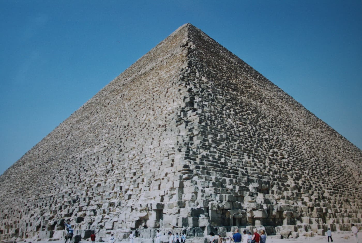 The Great Pyramid of Khufu seen from its base, with visitors at the foot