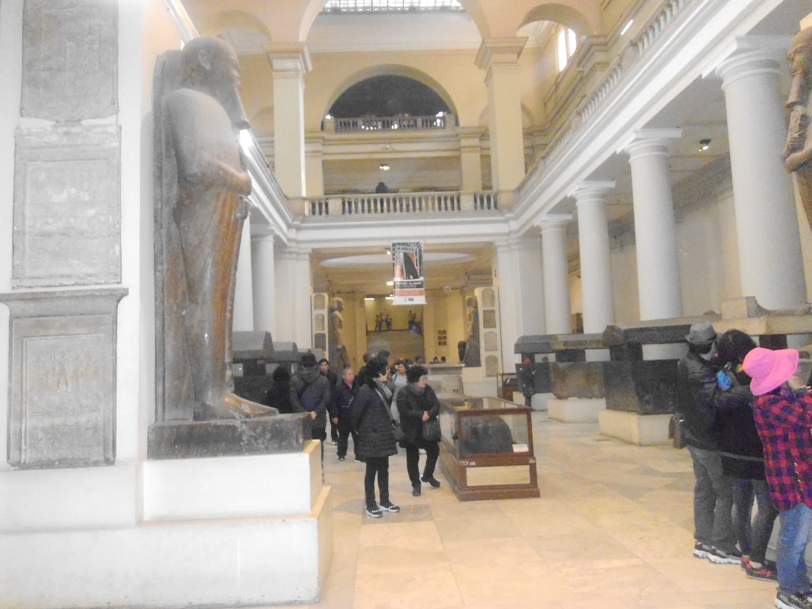 Visitors in a statue-lined hall of the Egyptian Museum in Cairo