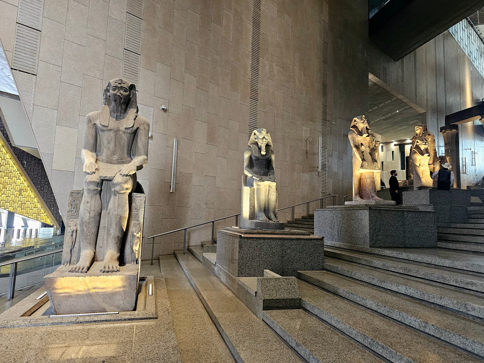 Colossal statues lining the grand staircase of the Grand Egyptian Museum