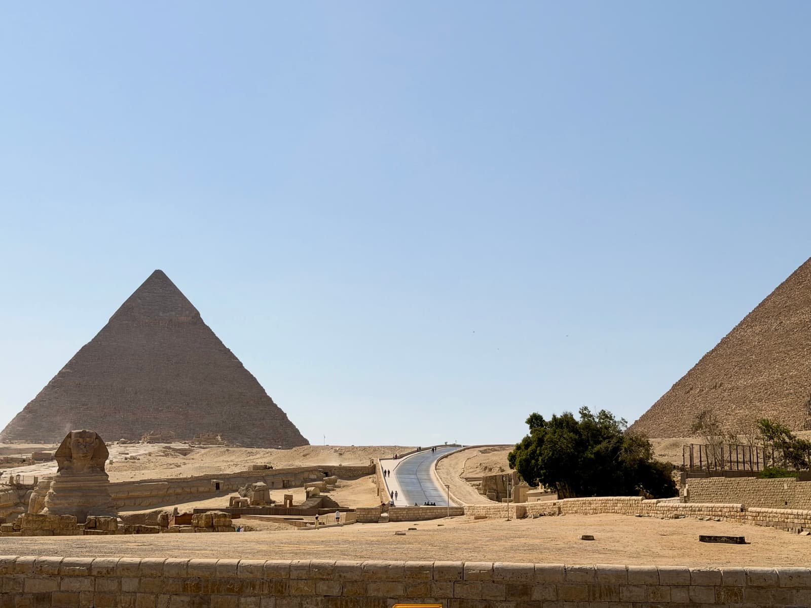 The Sphinx and the pyramids of Khafre and Khufu seen across the plateau